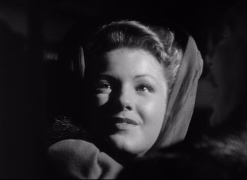 Movie still from “The Magnificent Ambersons” (1942), directed by Robert Wise – A black - and - white photo of a woman in a car; Close Up shot, Low angle