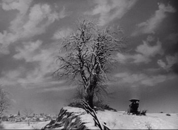 Movie still from “The Magnificent Ambersons” (1942), directed by Robert Wise – A tree and a car on a snowy hillside; Extreme Wide shot, Low angle