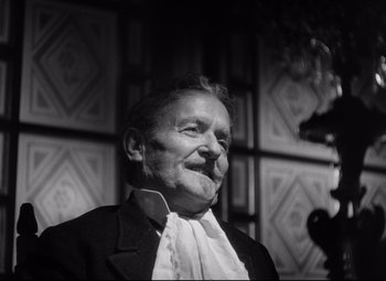 Movie still from “The Magnificent Ambersons” (1942), directed by Robert Wise – An older man wearing a suit and tie; Close Up shot, Low angle