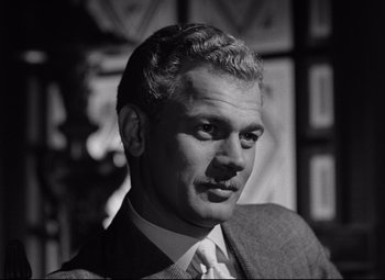Movie still from “The Magnificent Ambersons” (1942), directed by Robert Wise – Black and white photograph of a man wearing a suit and tie; Close Up shot, Low angle