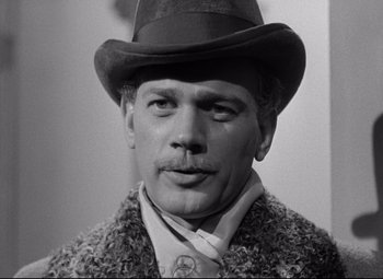 Movie still from “The Magnificent Ambersons” (1942), directed by Robert Wise – A black and white photo of a man wearing a hat; Close Up shot, Low angle