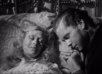 Movie still from “The Magnificent Ambersons” (1942), directed by Robert Wise – A man and a woman laying in a bed together; Close Up shot, High angle