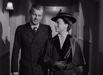 Movie still from “The Magnificent Ambersons” (1942), directed by Robert Wise – An older man standing next to an older woman; Medium shot, Low angle