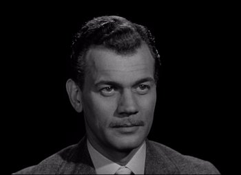 Movie still from “The Magnificent Ambersons” (1942), directed by Robert Wise – Black and white photograph of a man in a suit and tie; Close Up shot, High angle