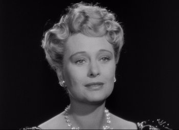 Movie still from “The Magnificent Ambersons” (1942), directed by Robert Wise – An old photo of a woman in a black and white photo; Close Up shot, Low angle