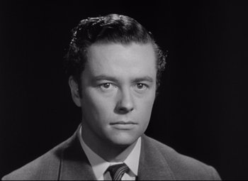 Movie still from “The Magnificent Ambersons” (1942), directed by Robert Wise – Black and white photograph of a man in a suit and tie; Close Up shot, Low angle