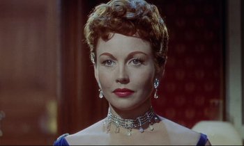 Movie still from “The Man Who Could Cheat Death” (1959), directed by Terence Fisher – A person wearing a necklace and earrings; Close Up shot, Low angle