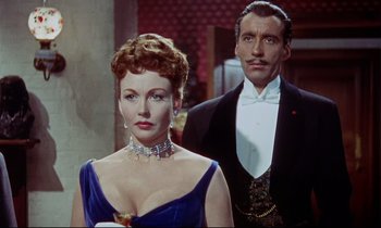 Movie still from “The Man Who Could Cheat Death” (1959), directed by Terence Fisher – A man and a woman standing next to each other; Medium shot, Low angle