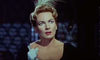 Movie still from “The Man Who Could Cheat Death” (1959), directed by Terence Fisher – A woman in a black dress and a white glove; Close Up shot, Low angle