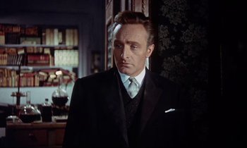 Movie still from “The Man Who Could Cheat Death” (1959), directed by Terence Fisher – A person wearing a suit and tie; Close Up shot, Low angle