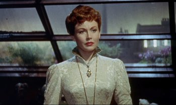 Movie still from “The Man Who Could Cheat Death” (1959), directed by Terence Fisher – A woman in a white dress with a necklace; Close Up shot, Low angle