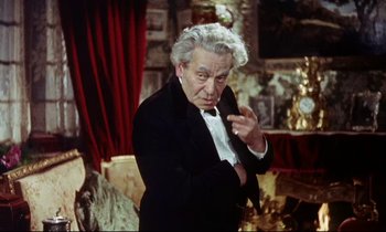 Movie still from “The Man Who Could Cheat Death” (1959), directed by Terence Fisher – An older man wearing a tuxedo and a bow tie; Medium shot, High angle