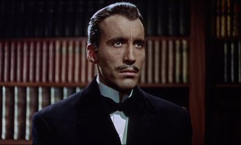 Movie still from “The Man Who Could Cheat Death” (1959), directed by Terence Fisher – A person wearing a suit and tie; Close Up shot, Low angle