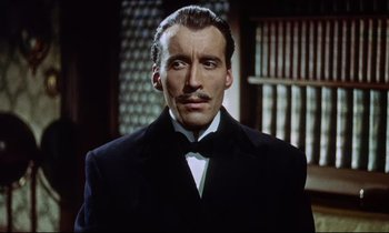 Movie still from “The Man Who Could Cheat Death” (1959), directed by Terence Fisher – A person wearing a suit and tie; Close Up shot, Low angle