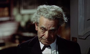 Movie still from “The Man Who Could Cheat Death” (1959), directed by Terence Fisher – An older man in a suit and white tie; Close Up shot, High angle