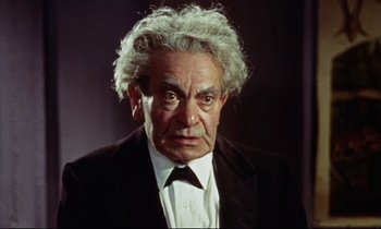 Movie still from “The Man Who Could Cheat Death” (1959), directed by Terence Fisher – An older man in a suit and white shirt; Close Up shot, Low angle