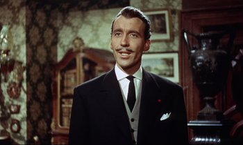 Movie still from “The Man Who Could Cheat Death” (1959), directed by Terence Fisher – A person wearing a suit and tie; Close Up shot, Low angle