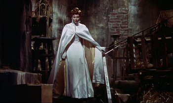 Movie still from “The Man Who Could Cheat Death” (1959), directed by Terence Fisher – A woman in a white dress holding a sword; Wide shot, Low angle