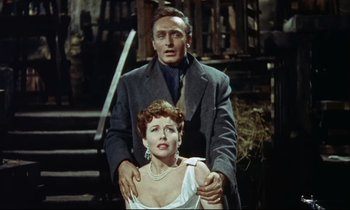 Movie still from “The Man Who Could Cheat Death” (1959), directed by Terence Fisher – A man and a woman standing next to each other; Medium shot, Low angle