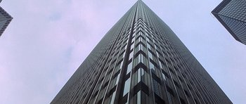 Movie still from “The Man Who Fell to Earth” (1976), directed by Nicolas Roeg – Looking up at a very tall skyscraper in a city; Extreme Wide shot, Low angle