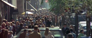 Movie still from “The Man Who Fell to Earth” (1976), directed by Nicolas Roeg – A crowd of people walking down a street; Extreme Wide shot, High angle