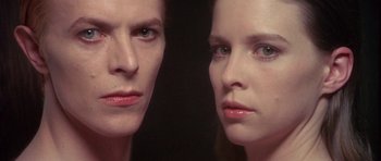 Movie still from “The Man Who Fell to Earth” (1976), directed by Nicolas Roeg – A woman is looking at her reflection in a mirror; Close Up shot, Overhead angle