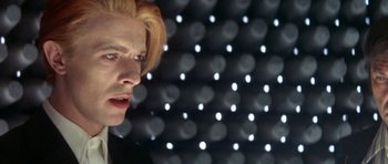Movie still from “The Man Who Fell to Earth” (1976), directed by Nicolas Roeg – A man with blonde hair is looking into the distance; Close Up shot, Low angle