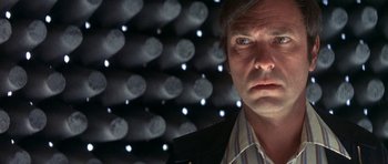 Movie still from “The Man Who Fell to Earth” (1976), directed by Nicolas Roeg – A person wearing a suit and tie; Close Up shot, Low angle