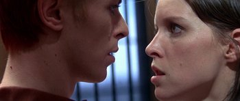 Movie still from “The Man Who Fell to Earth” (1976), directed by Nicolas Roeg – A man and a woman face to face in front of a window; Extreme Close Up shot, Low angle