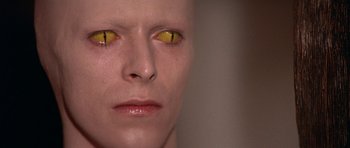 Movie still from “The Man Who Fell to Earth” (1976), directed by Nicolas Roeg – A person's face with yellow eyes; Close Up shot, Overhead angle