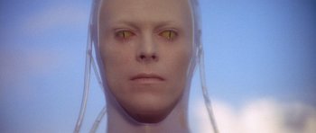 Movie still from “The Man Who Fell to Earth” (1976), directed by Nicolas Roeg – An image of a man with yellow eyes; Close Up shot, Overhead angle