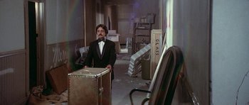 Movie still from “The Man Who Fell to Earth” (1976), directed by Nicolas Roeg – A man in a suit standing in an empty room; Wide shot, High angle