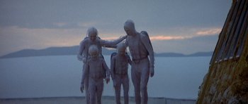 Movie still from “The Man Who Fell to Earth” (1976), directed by Nicolas Roeg – A group of people dressed in body suits walking; Wide shot, High angle