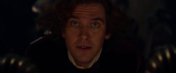 Movie still from “The Man Who Invented Christmas” (2017), directed by Bharat Nalluri – A man's face in the dark; Close Up shot, Low angle