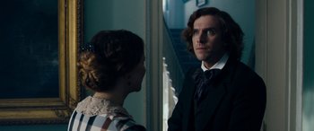 Movie still from “The Man Who Invented Christmas” (2017), directed by Bharat Nalluri – A man and a woman looking at each other in a room; Close Up shot, Over the shoulder angle