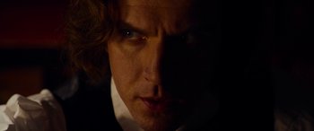 Movie still from “The Man Who Invented Christmas” (2017), directed by Bharat Nalluri – A man's face in the dark; Extreme Close Up shot, Over the shoulder angle