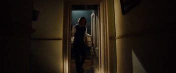 Movie still from “The Man Who Invented Christmas” (2017), directed by Bharat Nalluri – A man standing at the door of a room; Wide shot, Low angle