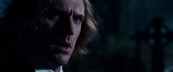 Movie still from “The Man Who Invented Christmas” (2017), directed by Bharat Nalluri – A man's face in the dark; Close Up shot, Low angle