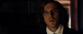 Movie still from “The Man Who Invented Christmas” (2017), directed by Bharat Nalluri – A person wearing a suit and tie; Close Up shot, Over the shoulder angle