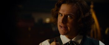 Movie still from “The Man Who Invented Christmas” (2017), directed by Bharat Nalluri – A person wearing a shirt and a tie; Close Up shot, Over the shoulder angle