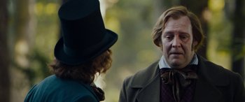 Movie still from “The Man Who Invented Christmas” (2017), directed by Bharat Nalluri – A man and a woman talking to each other outside; Close Up shot, Over the shoulder angle