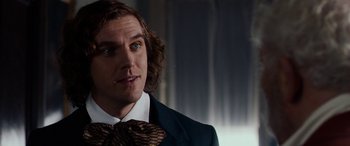 Movie still from “The Man Who Invented Christmas” (2017), directed by Bharat Nalluri – A person wearing a suit and tie; Close Up shot, Over the shoulder angle