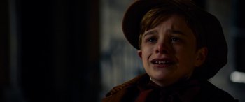 Movie still from “The Man Who Invented Christmas” (2017), directed by Bharat Nalluri – A young boy with a hat on crying; Close Up shot, High angle
