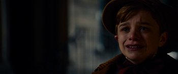 Movie still from “The Man Who Invented Christmas” (2017), directed by Bharat Nalluri – A young boy wearing a brown hat and a brown jacket; Close Up shot, High angle