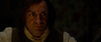 Movie still from “The Man Who Invented Christmas” (2017), directed by Bharat Nalluri – A person wearing a suit and tie; Close Up shot, Over the shoulder angle