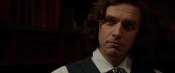 Movie still from “The Man Who Invented Christmas” (2017), directed by Bharat Nalluri – A person wearing a tie; Close Up shot, Over the shoulder angle