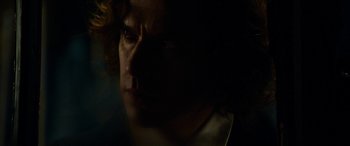 Movie still from “The Man Who Invented Christmas” (2017), directed by Bharat Nalluri – A person's face in the dark; Close Up shot, Over the shoulder angle