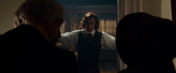 Movie still from “The Man Who Invented Christmas” (2017), directed by Bharat Nalluri – A man standing in front of a mirror; Medium shot, Over the shoulder angle