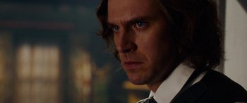 Movie still from “The Man Who Invented Christmas” (2017), directed by Bharat Nalluri – A person wearing a suit and tie; Close Up shot, Over the shoulder angle
