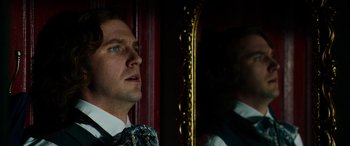 Movie still from “The Man Who Invented Christmas” (2017), directed by Bharat Nalluri – A man looking at himself in the mirror; Close Up shot, Over the shoulder angle